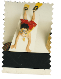 a black and white photo of a child laying on a table